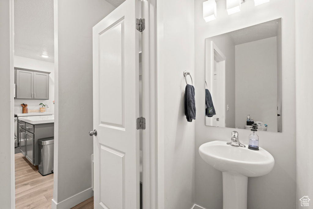 Bathroom featuring wood finished floors and baseboards