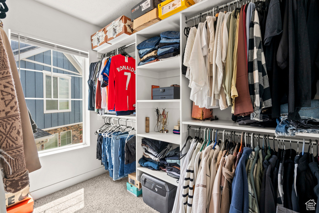 Walk in closet featuring carpet flooring