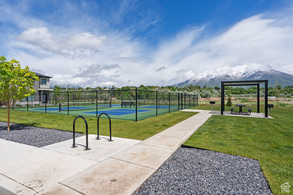 View of community with a tennis court and a mountain view