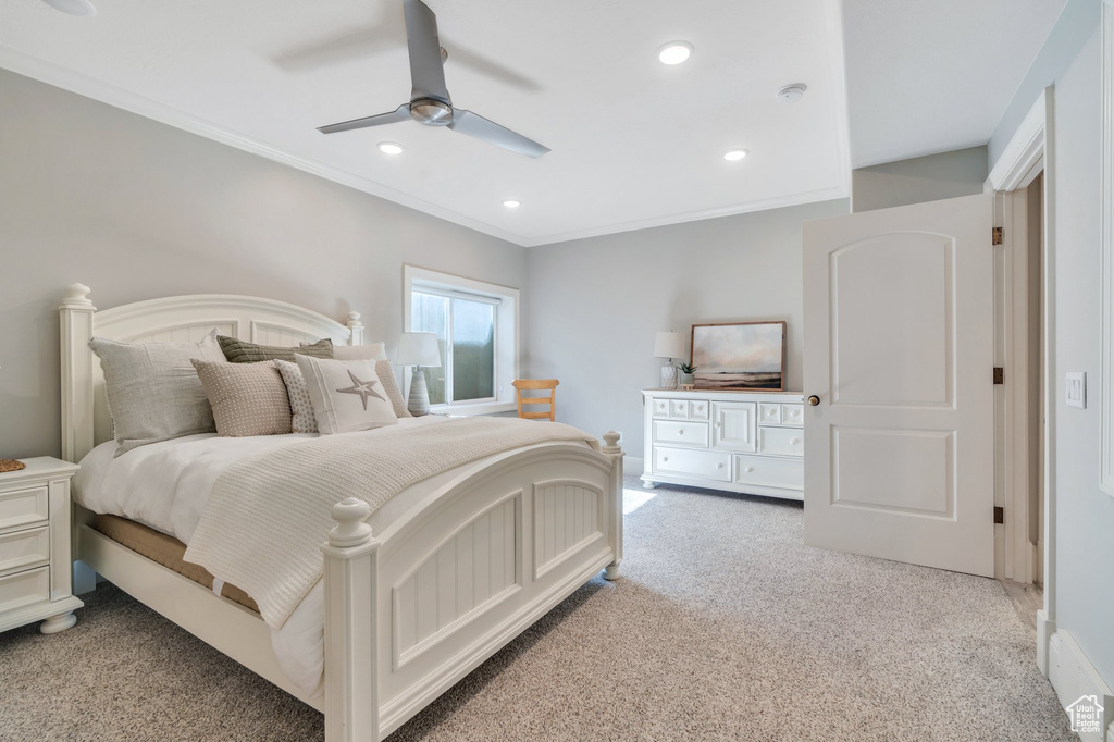 Bedroom with light colored carpet, recessed lighting, ornamental molding, a ceiling fan, and baseboards