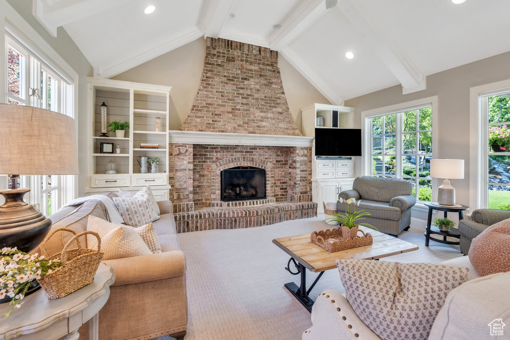 Living room with a brick fireplace and recessed lighting