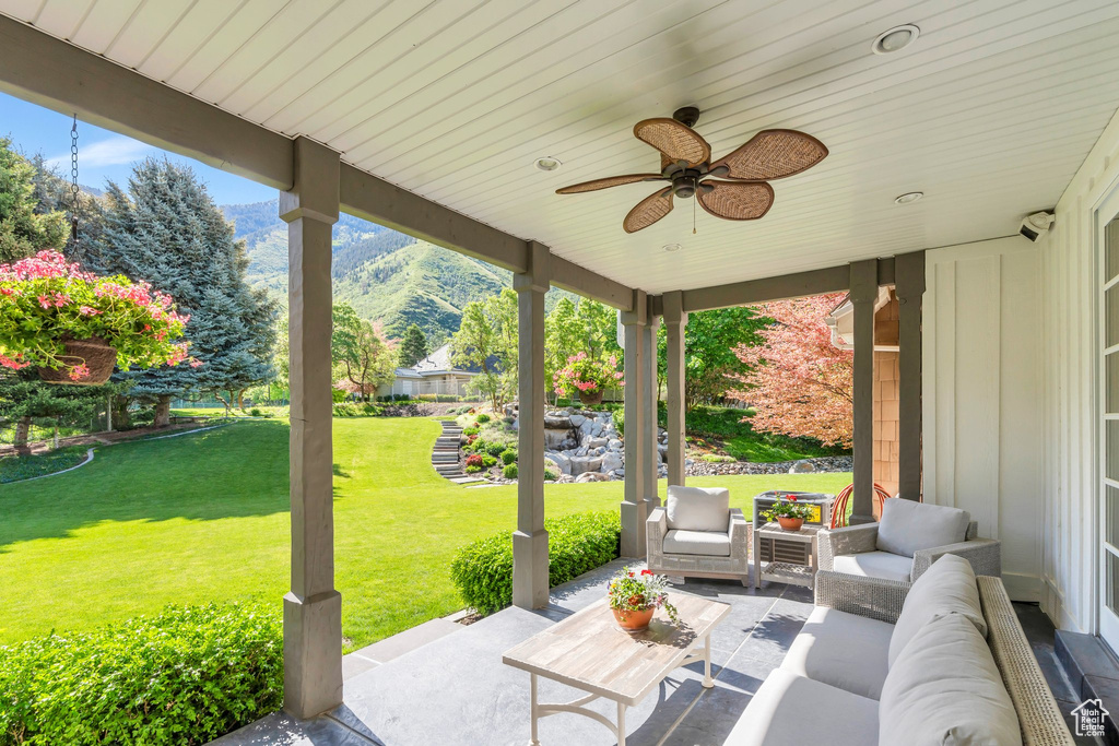 View of patio featuring a mountain view, outdoor lounge area, and a ceiling fan
