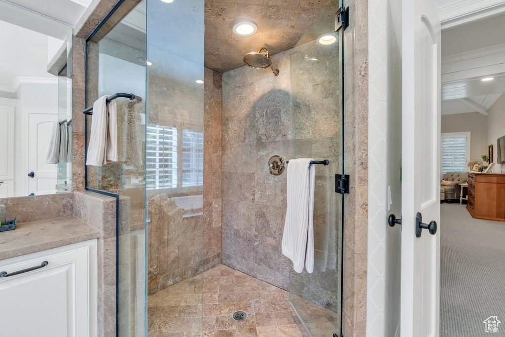 Full bath featuring ornamental molding, a stall shower, and vanity