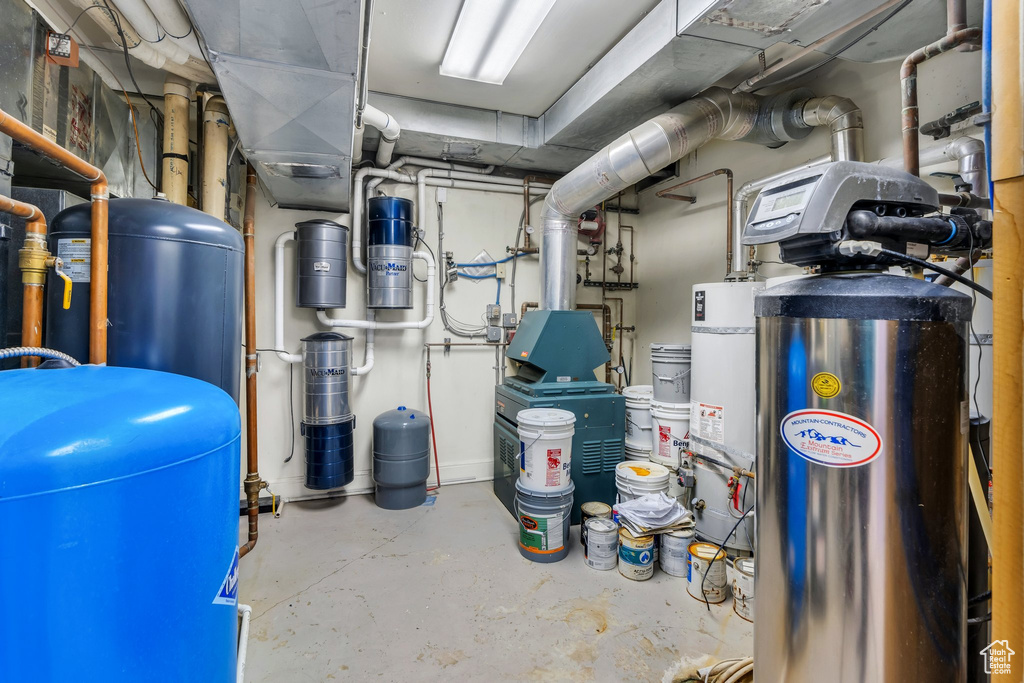 Utility room featuring gas water heater and a central vacuum unit