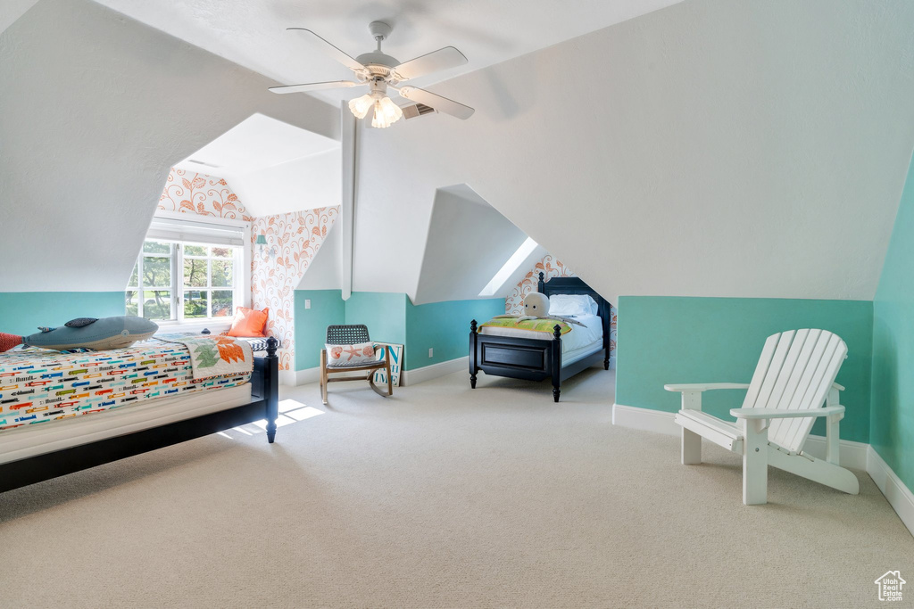 Bedroom with baseboards, carpet floors, vaulted ceiling, and a ceiling fan