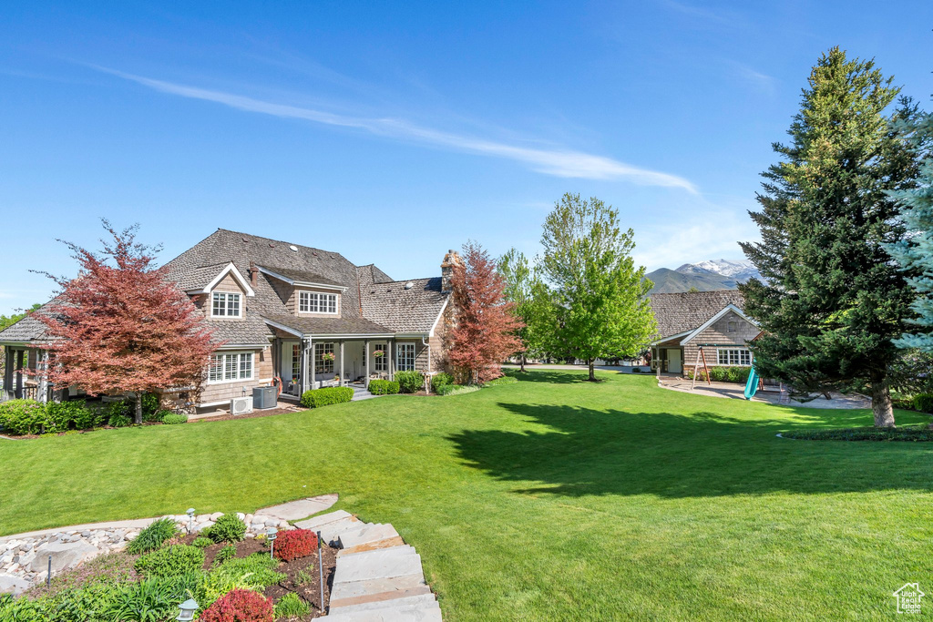 View of grassy yard with a porch