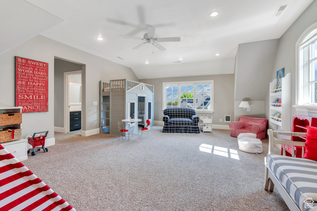 Living room with a ceiling fan, carpet floors, baseboards, recessed lighting, and lofted ceiling