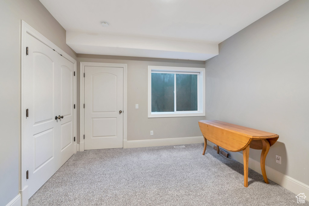 Living area with carpet floors and baseboards