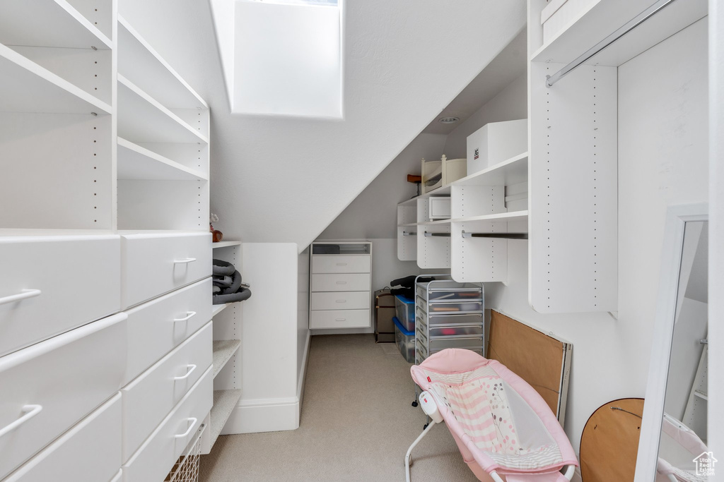 Walk in closet with light carpet