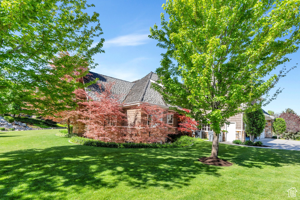View of home\\\\\\\\\\\\\\\'s exterior with a lawn and stone siding