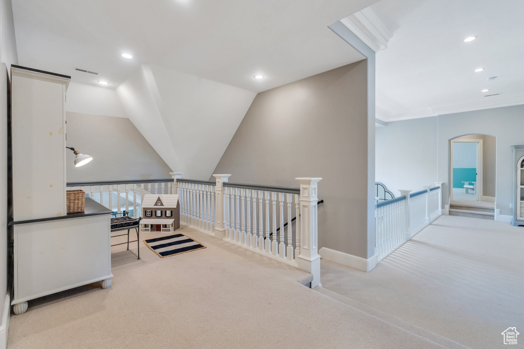 Hall featuring carpet flooring, an upstairs landing, recessed lighting, baseboards, and arched walkways