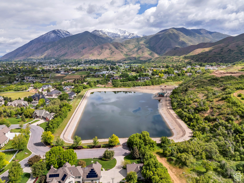 View of mountain background featuring nearby suburban area and a large body of water