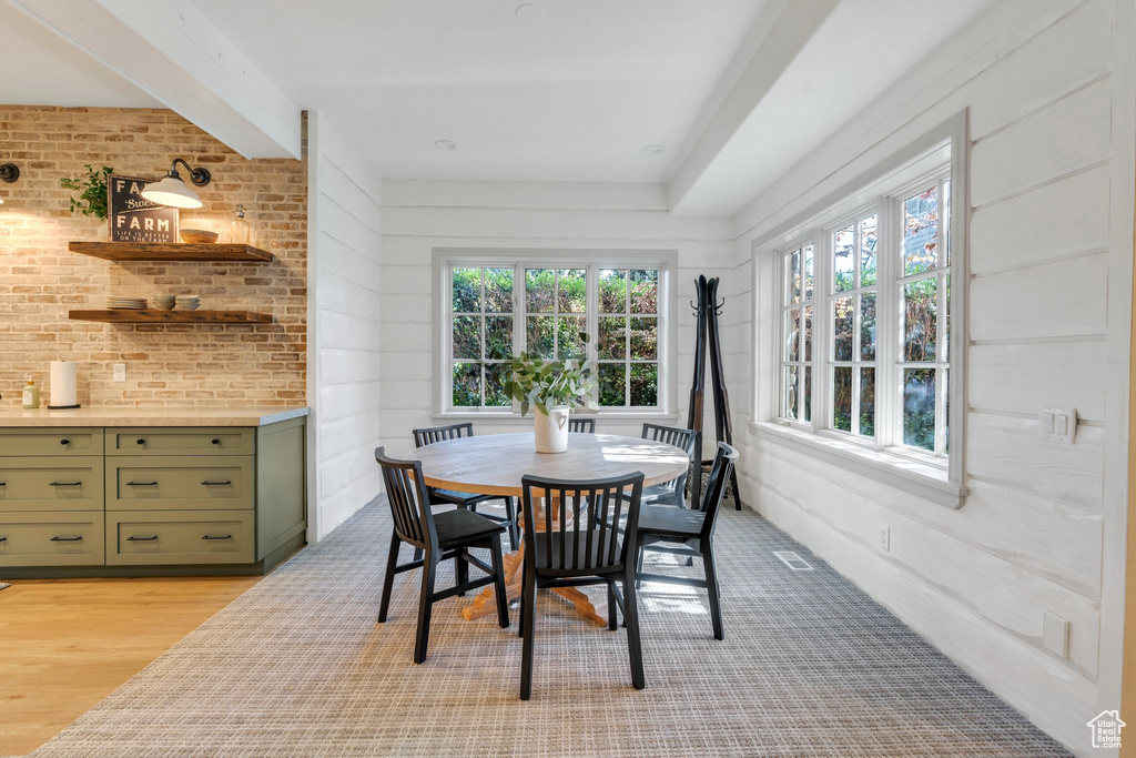 Dining space with healthy amount of natural light and light wood-style flooring