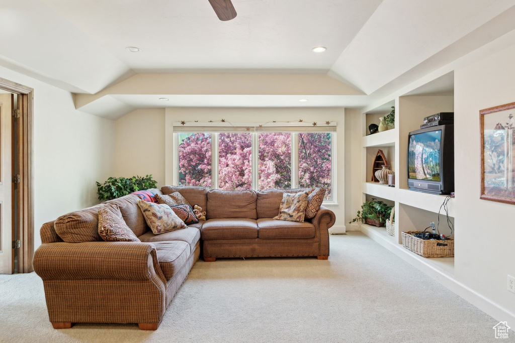 Living room featuring carpet flooring, lofted ceiling, built in features, ceiling fan, and recessed lighting