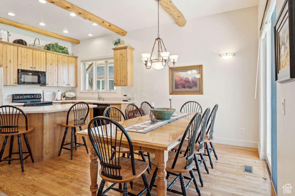 Dining area featuring recessed lighting, light wood-style floors, beam ceiling, a chandelier, and baseboards