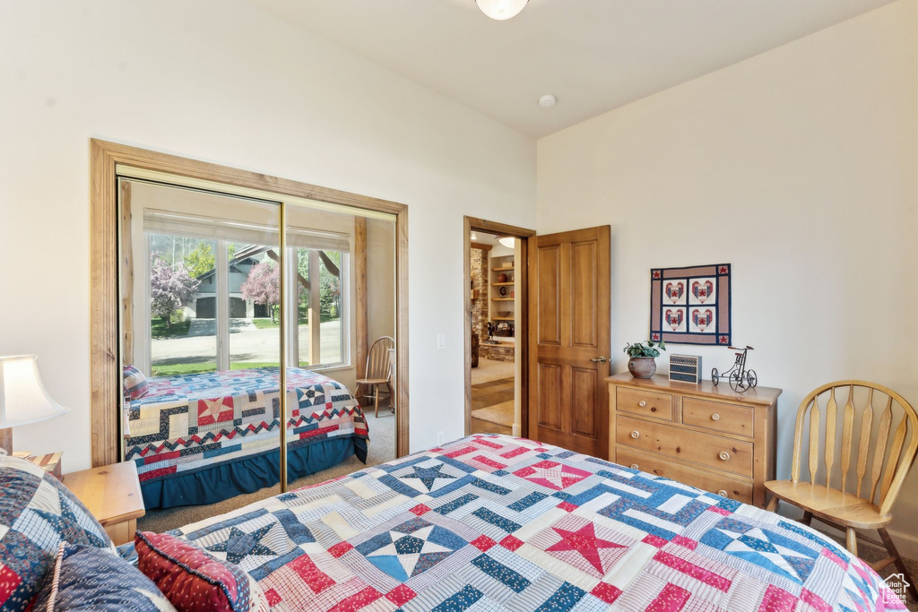 Bedroom featuring carpet floors and a towering ceiling