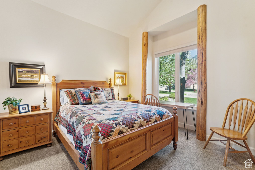 Bedroom featuring light carpet and lofted ceiling