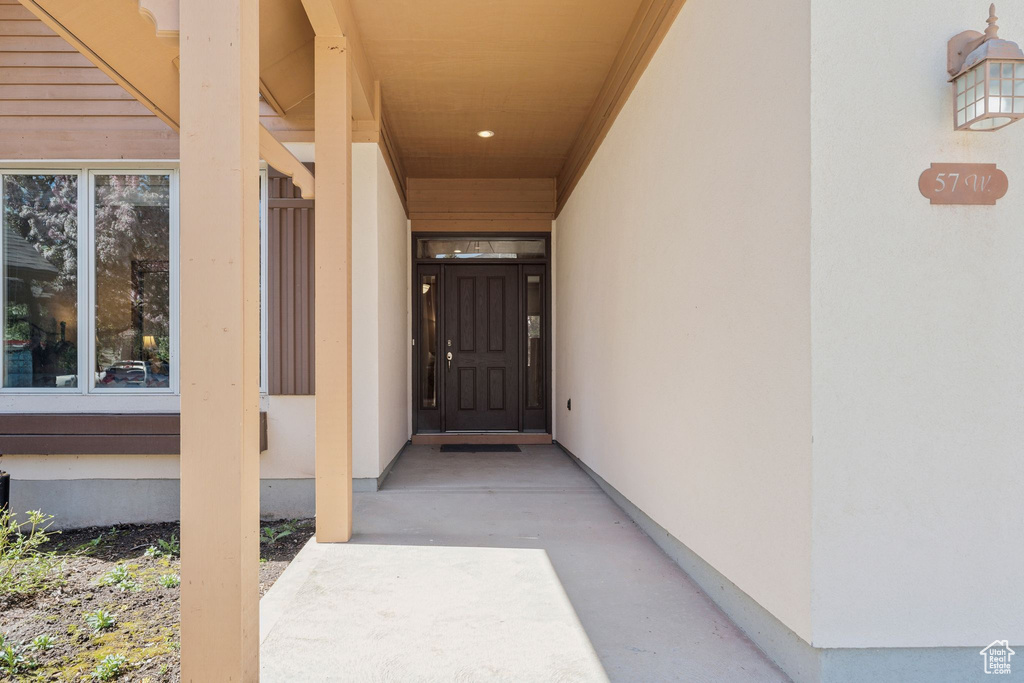 Entrance to property with stucco siding