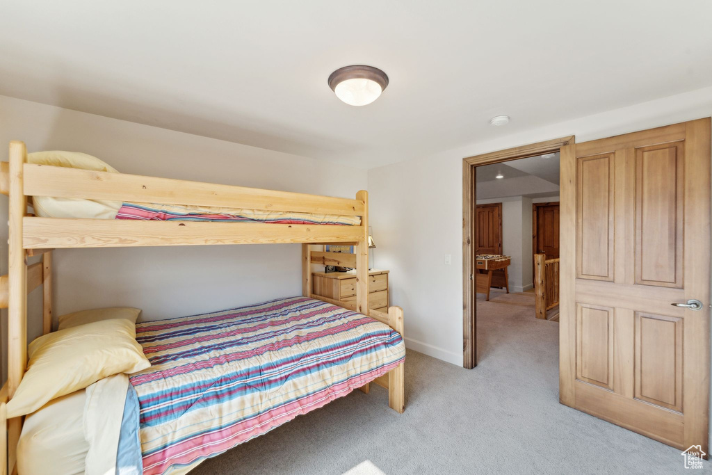 Bedroom featuring light colored carpet and baseboards