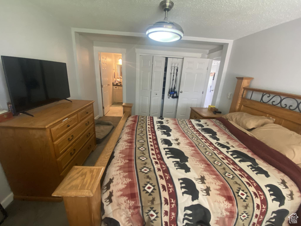 Bedroom featuring a textured ceiling and a closet