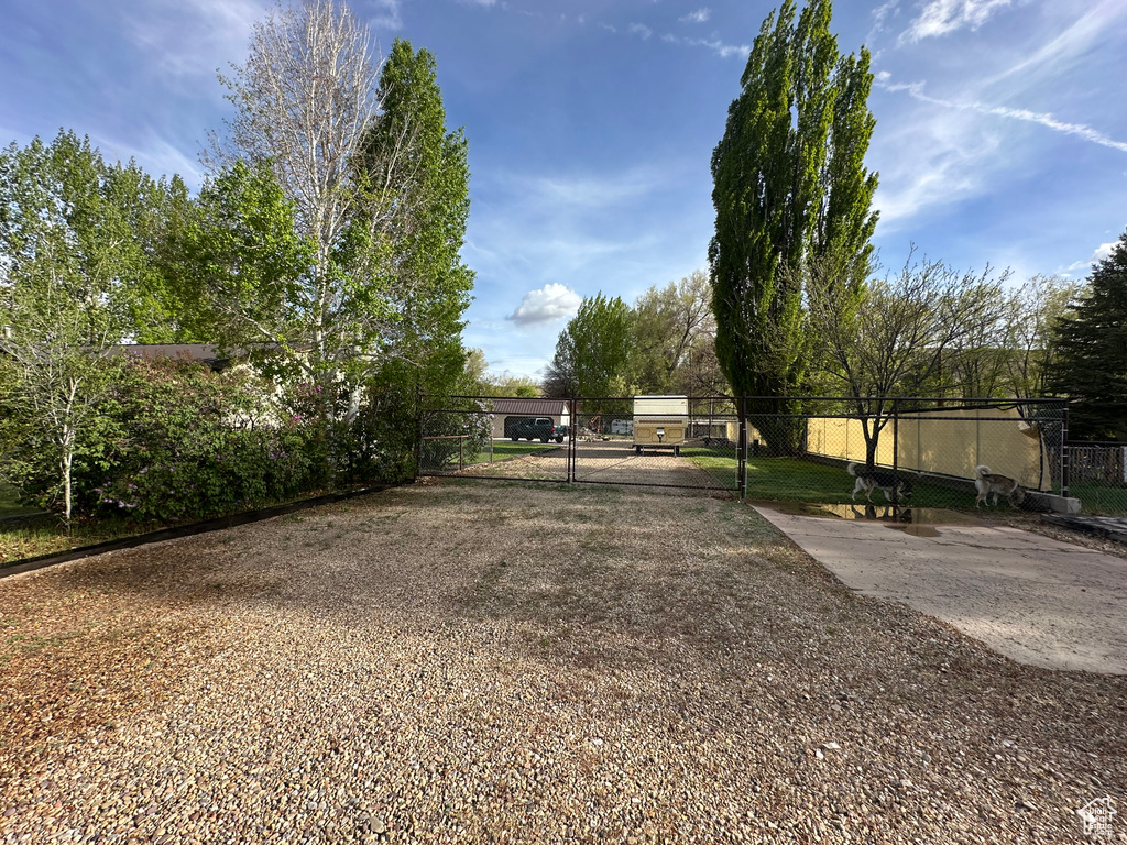 View of yard featuring a gate and fence