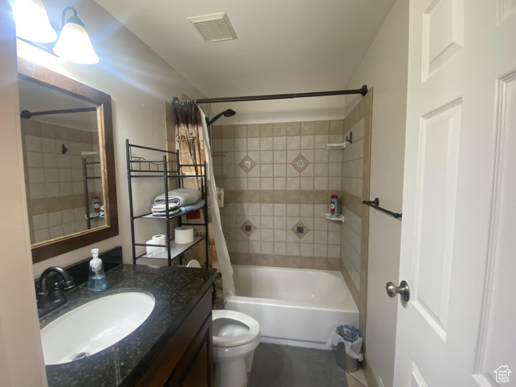 Full bath with vanity, toilet, and shower / bathtub combination with curtain