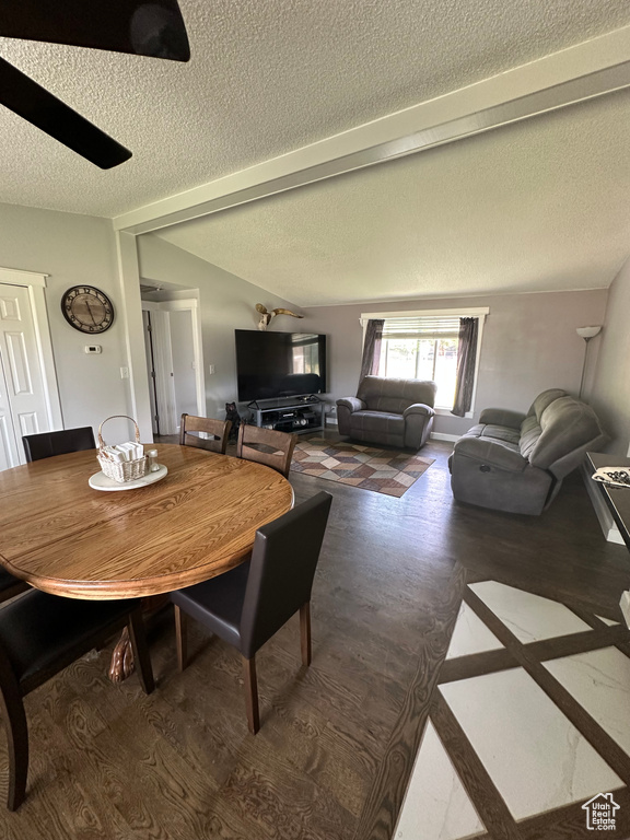Dining space with a textured ceiling and wood finished floors