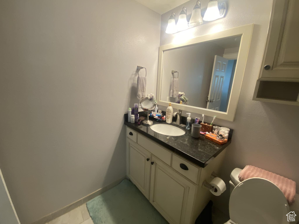 Half bath with vanity and baseboards