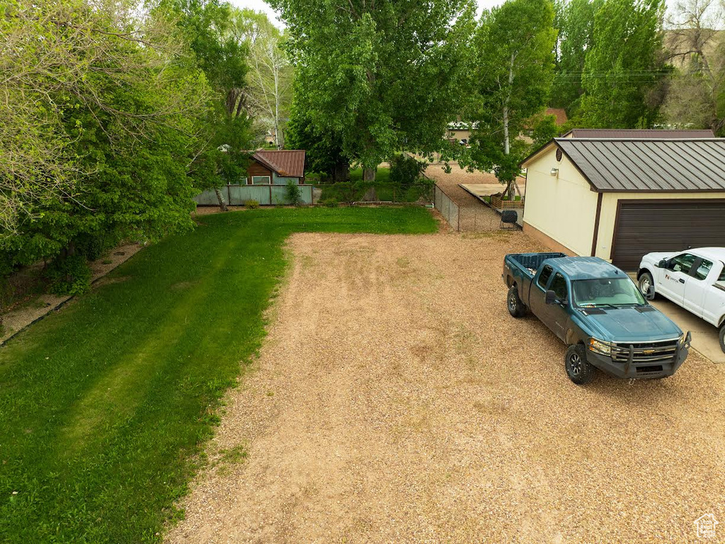 View of yard featuring fence and an outdoor structure