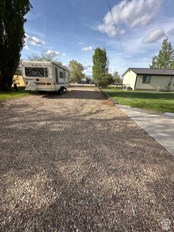 View of grassy yard with driveway