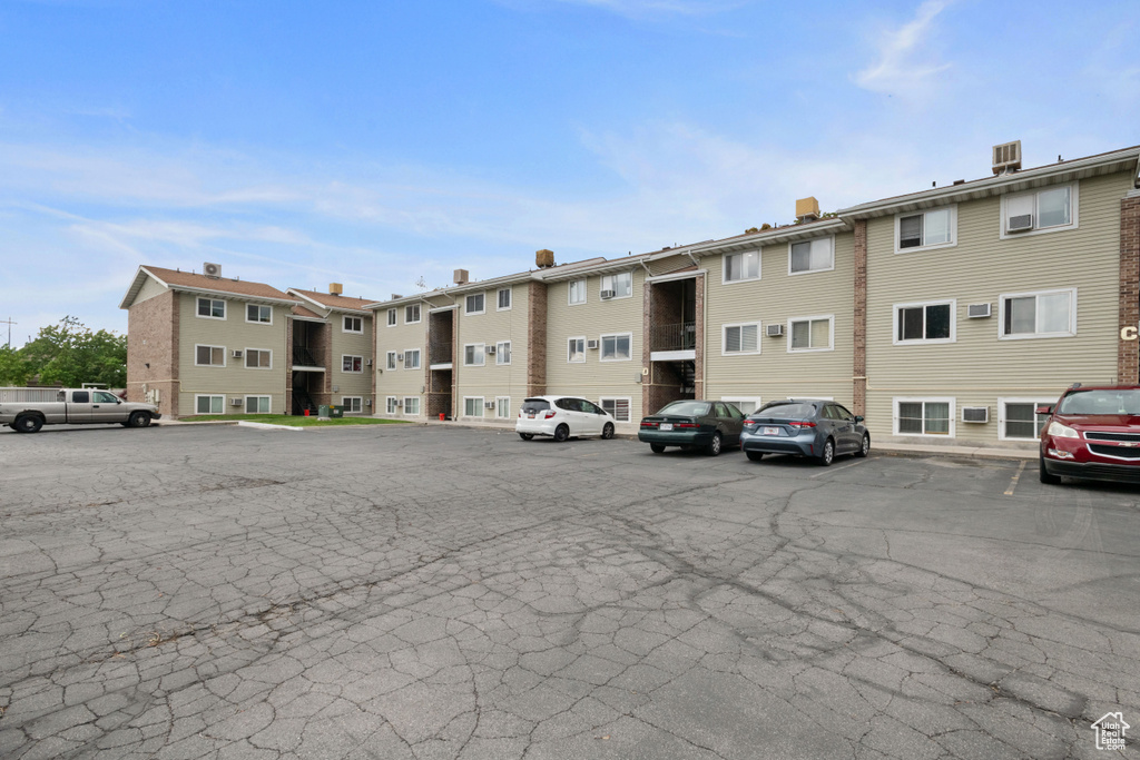 View of building exterior featuring uncovered parking