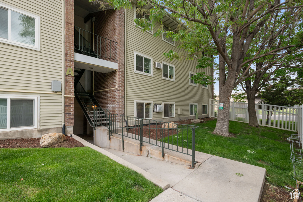 View of building exterior with fence and stairs