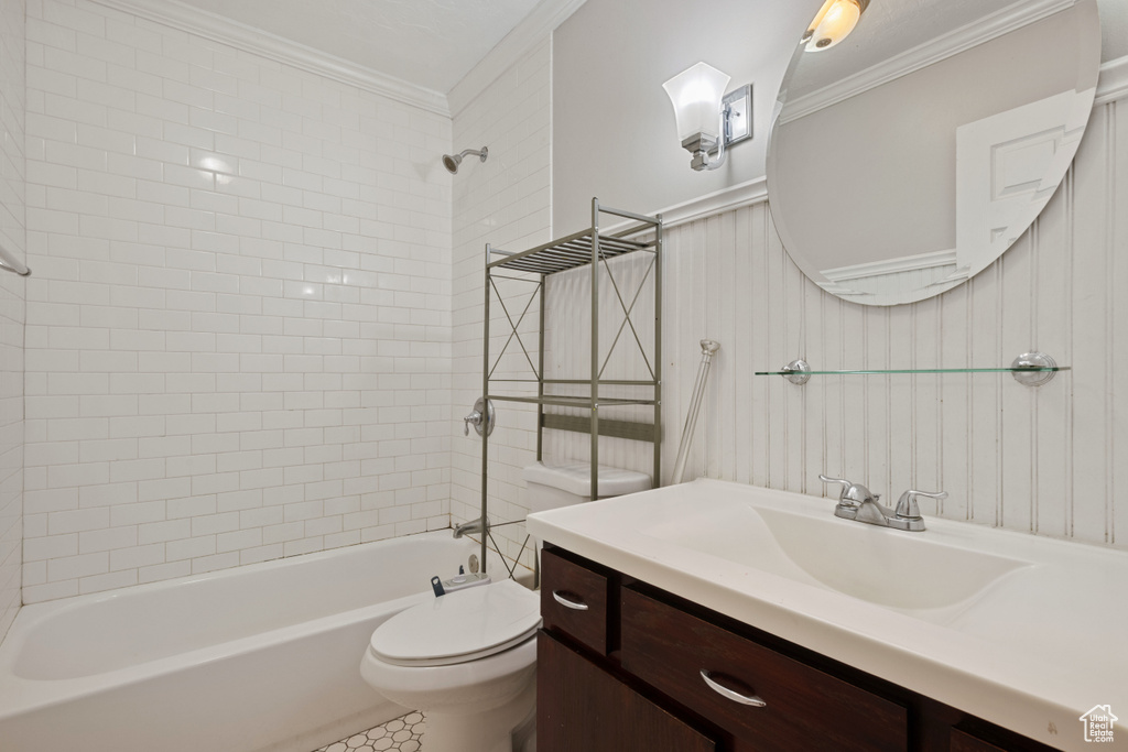 Bathroom with ornamental molding, toilet, shower / bathtub combination, and vanity