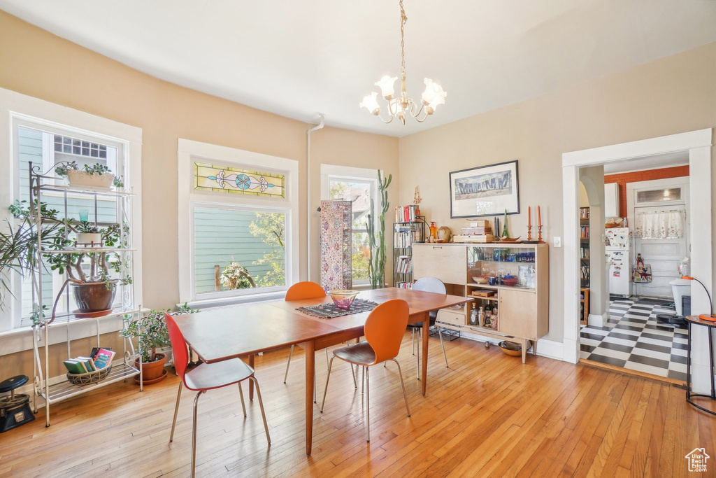 Dining area featuring a chandelier and light wood-style flooring