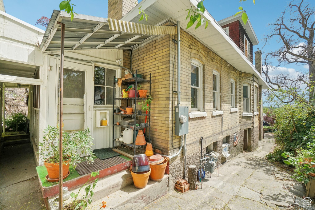 View of home's exterior with a chimney and brick siding