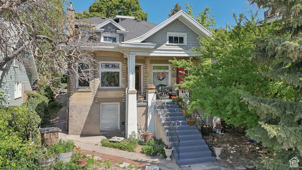 Craftsman-style house with stairs and covered porch