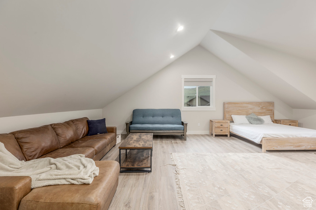 Bedroom featuring wood finished floors, lofted ceiling, recessed lighting, and baseboards