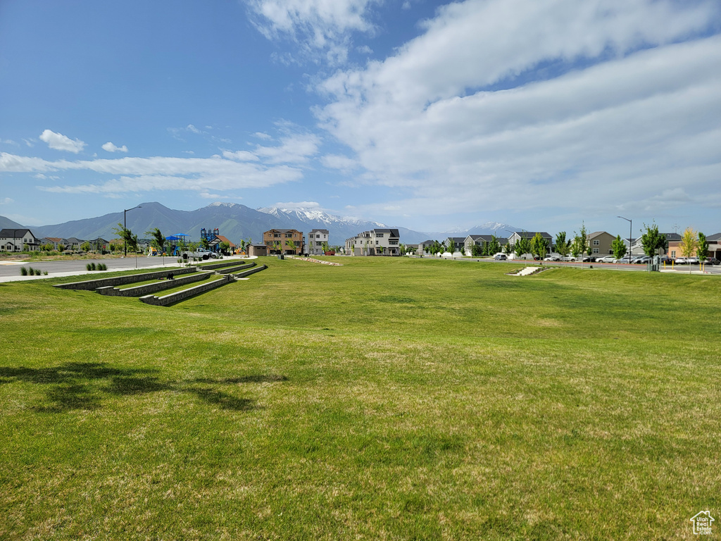 View of home\'s community featuring a mountain view and a yard