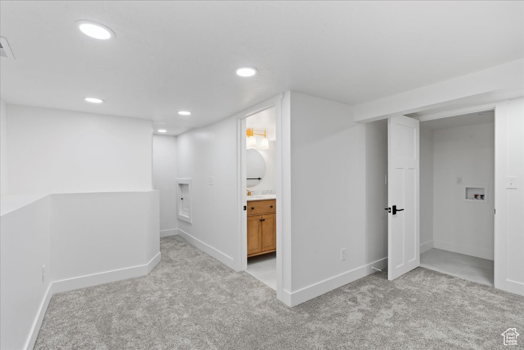 Finished below grade area with carpet, baseboards, and recessed lighting