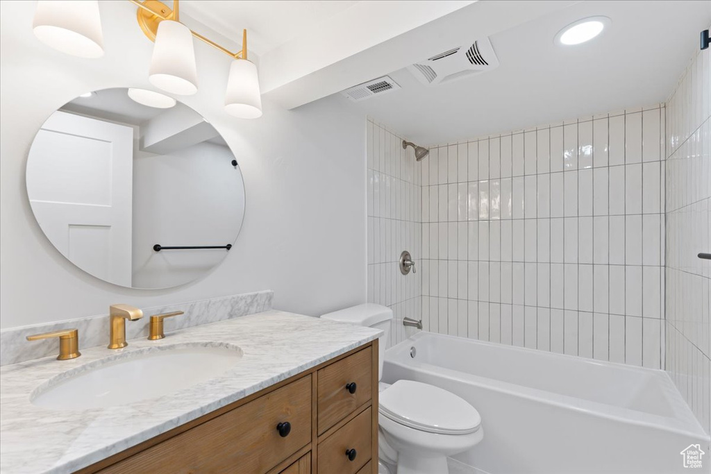 Full bathroom with toilet, shower / bathtub combination, and vanity