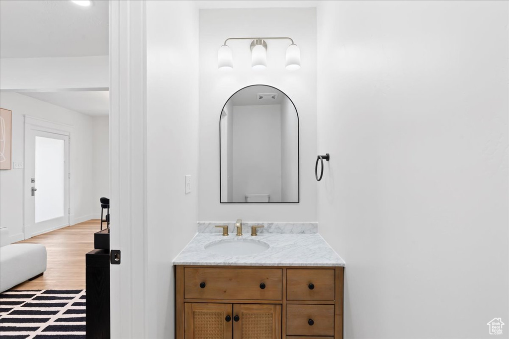 Bathroom with vanity and wood finished floors