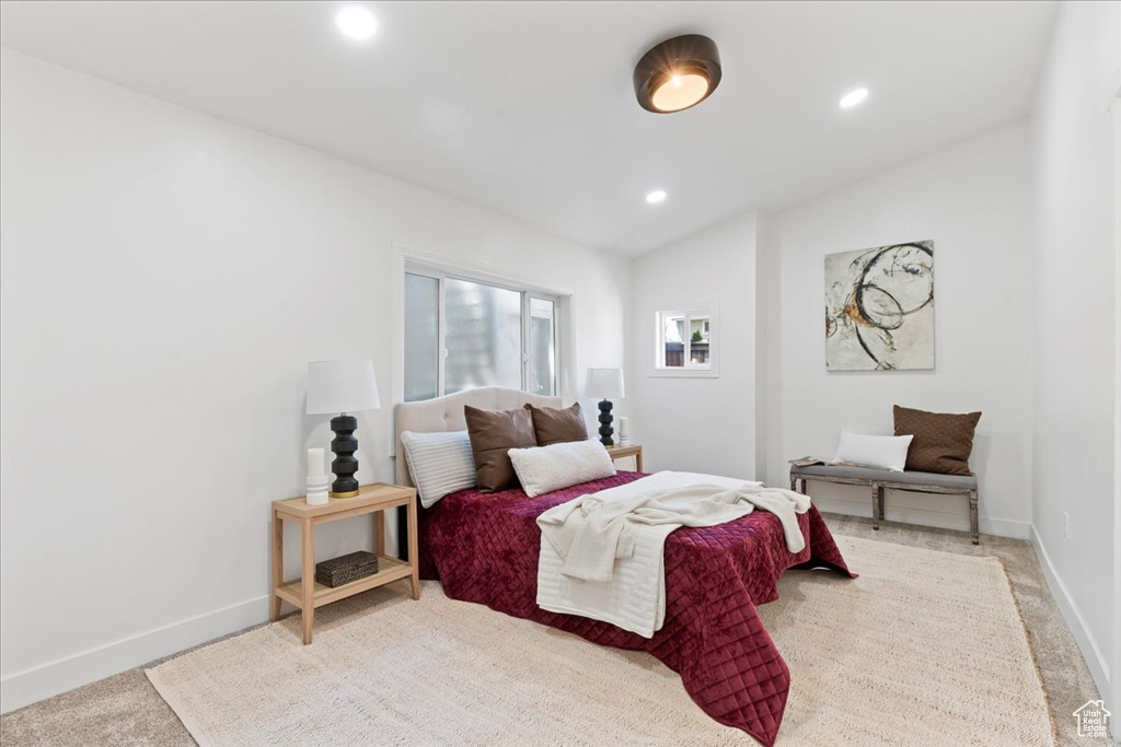 Bedroom with vaulted ceiling, recessed lighting, baseboards, and carpet
