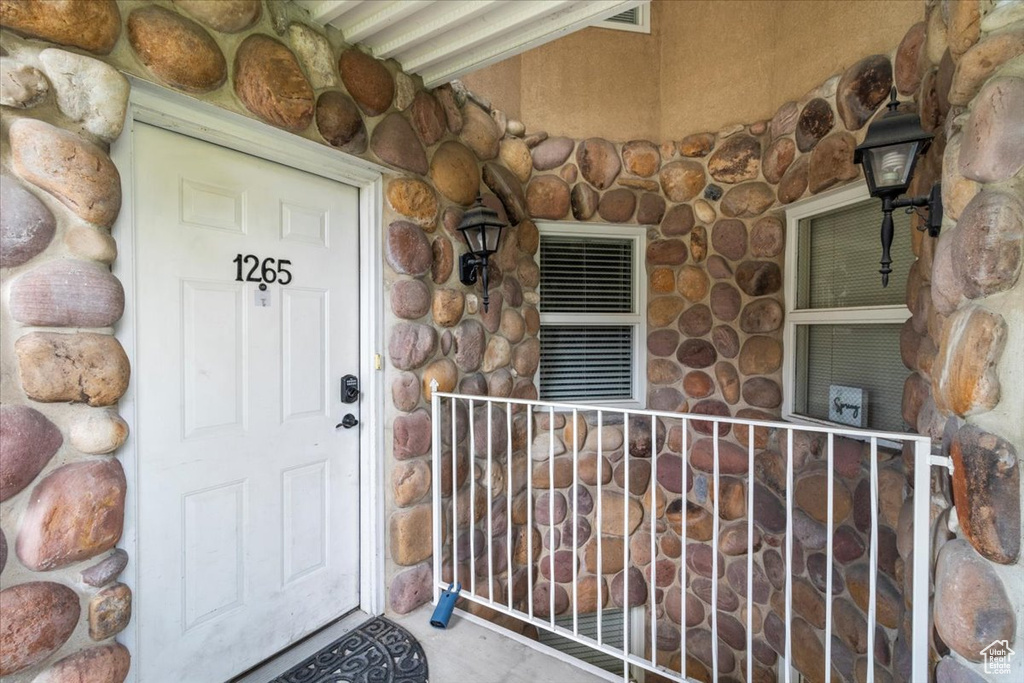 Entrance to property with stone siding