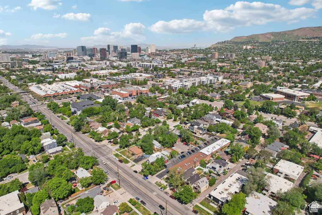 Aerial overview of property's location featuring nearby urban area and a mountainous background