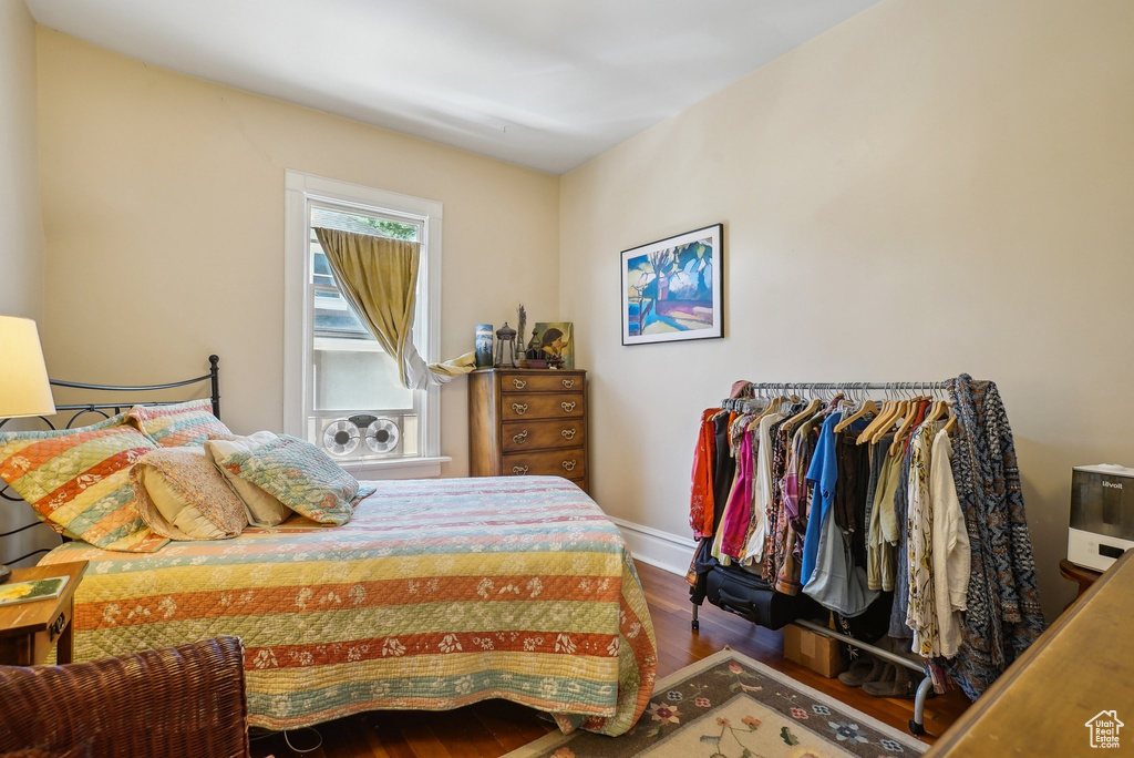 Bedroom with wood finished floors and baseboards