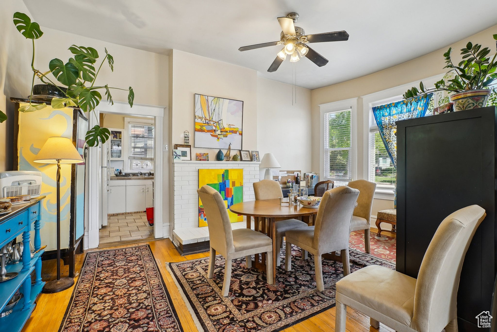 Dining room featuring plenty of natural light, light wood-style flooring, and a ceiling fan