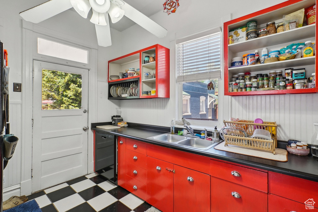Kitchen featuring red cabinetry, open shelves, tile patterned floors, and black dishwasher