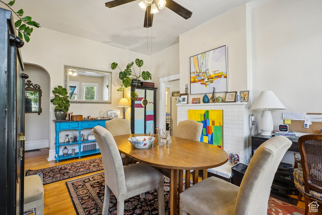 Dining area with ceiling fan and wood finished floors