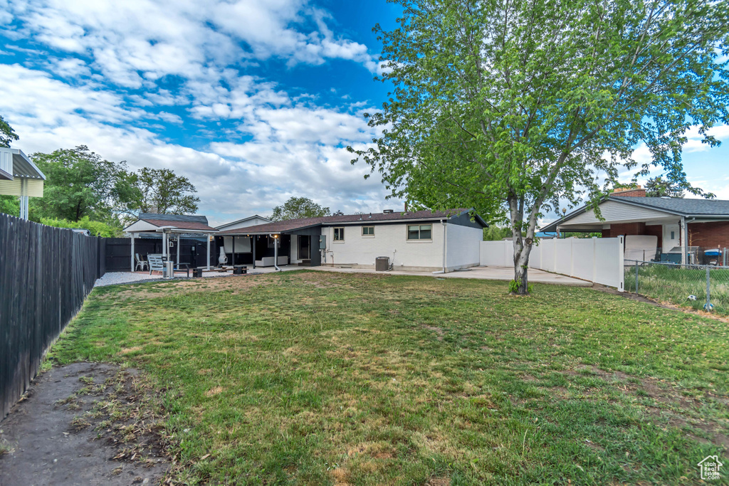 Rear view of property featuring a patio area