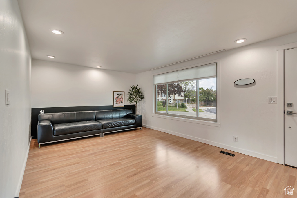 Living room featuring wood finished floors, baseboards, and recessed lighting